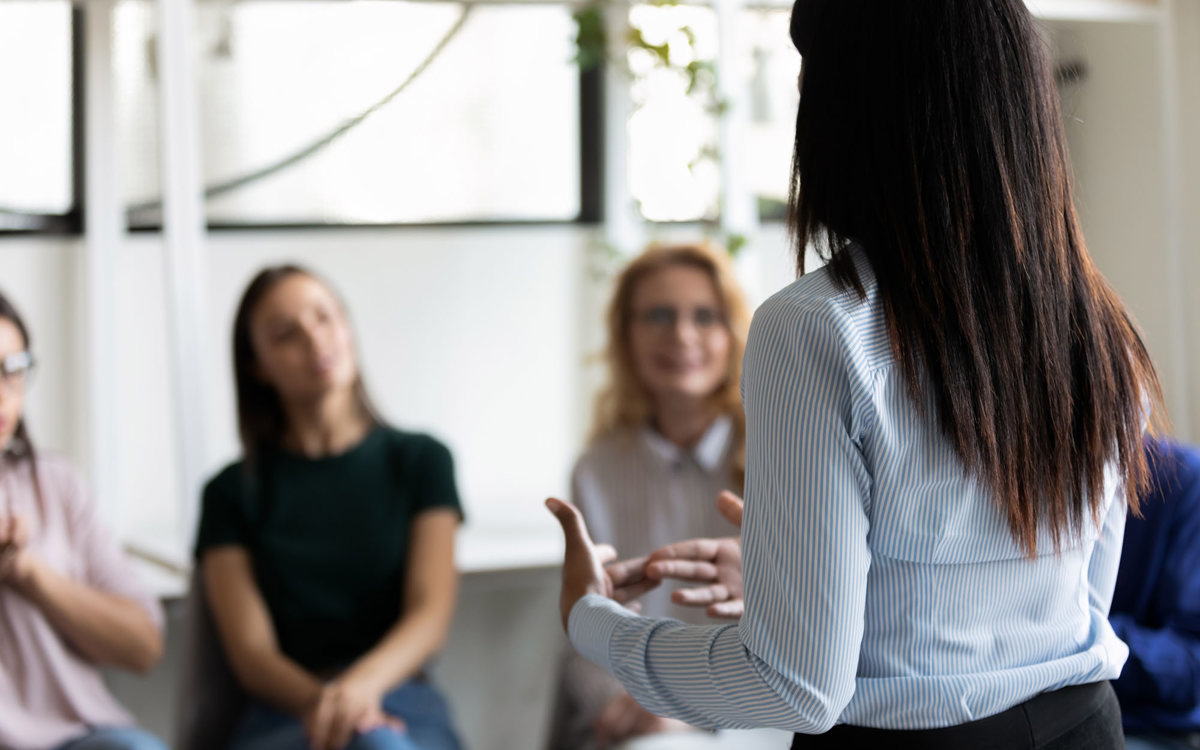 training woman talking to a small group